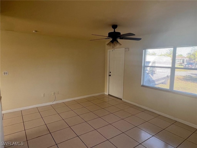 tiled empty room with ceiling fan