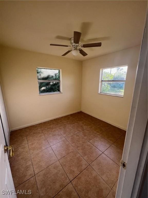 unfurnished room with light tile patterned floors and ceiling fan