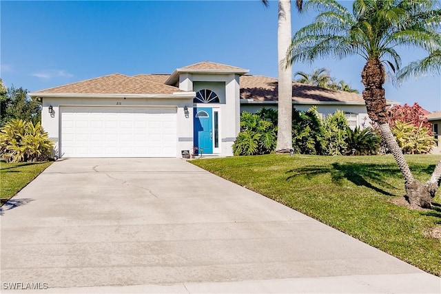 view of front of house with a front yard and a garage