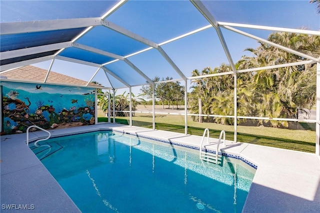 view of swimming pool featuring a yard, a patio, and a lanai