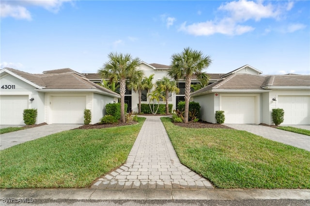 ranch-style home with a front yard and a garage