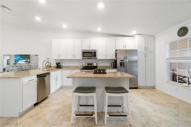 kitchen featuring kitchen peninsula, white cabinetry, sink, and appliances with stainless steel finishes