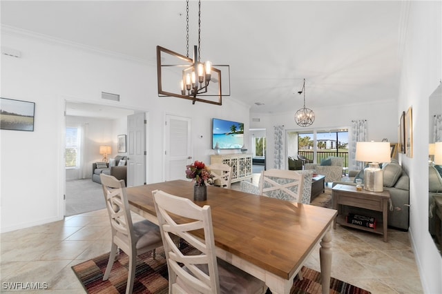 dining room with ornamental molding, a notable chandelier, and light tile patterned flooring