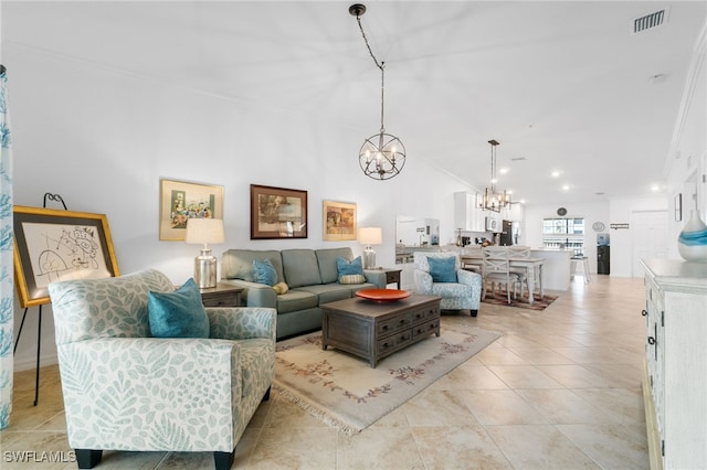 tiled living room featuring a notable chandelier and crown molding