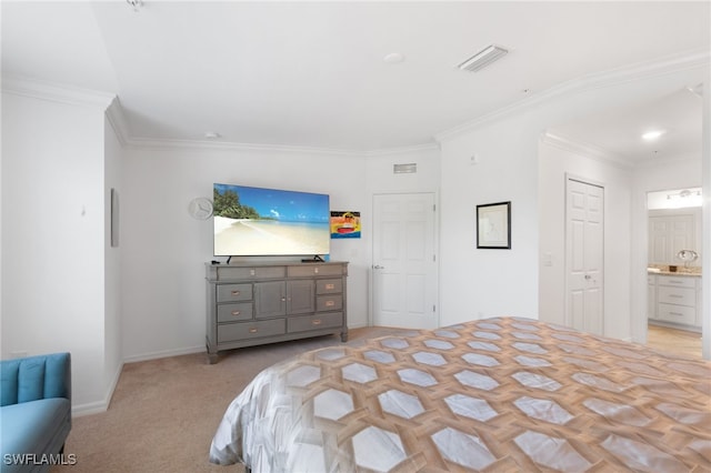 carpeted bedroom with ensuite bathroom and ornamental molding