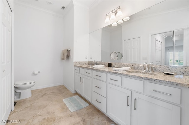 bathroom featuring vanity, toilet, and ornamental molding