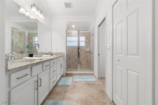 bathroom featuring ornamental molding, vanity, and a shower with shower door