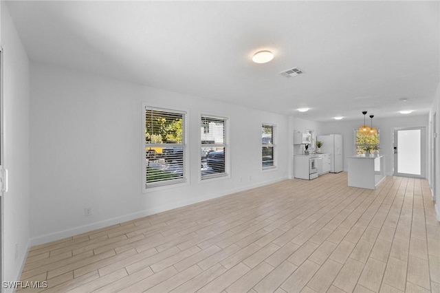 unfurnished living room with light hardwood / wood-style floors