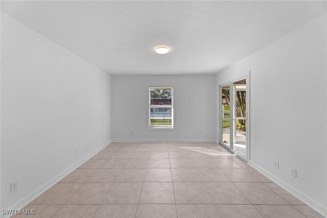 2722 Arbutus St Unit C2, Naples, FL 34112 - unfurnished room with light tile patterned floors and baseboards