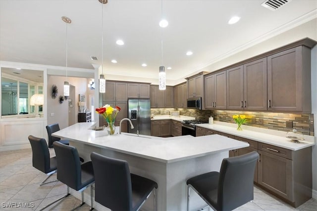 kitchen featuring a breakfast bar area, a large island, hanging light fixtures, and stainless steel appliances