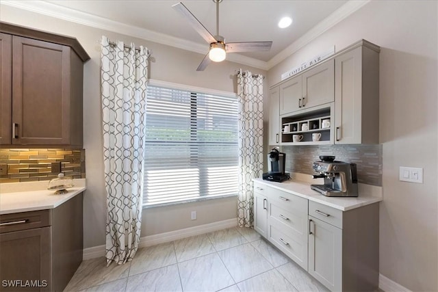 kitchen with decorative backsplash, plenty of natural light, and crown molding