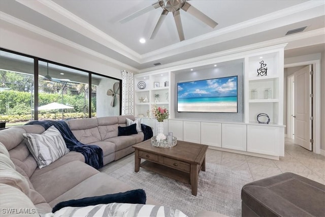 living room with ceiling fan, crown molding, and built in features