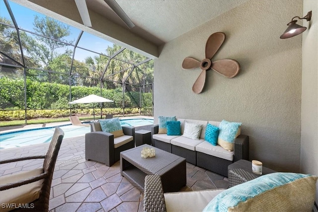 view of patio / terrace with an outdoor living space, glass enclosure, and ceiling fan