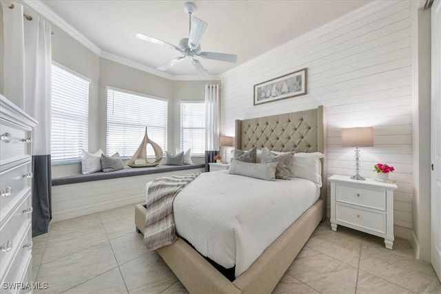 bedroom with ceiling fan, wood walls, light tile patterned floors, and ornamental molding