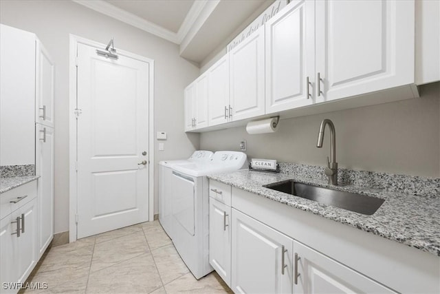 washroom featuring cabinets, sink, separate washer and dryer, and crown molding