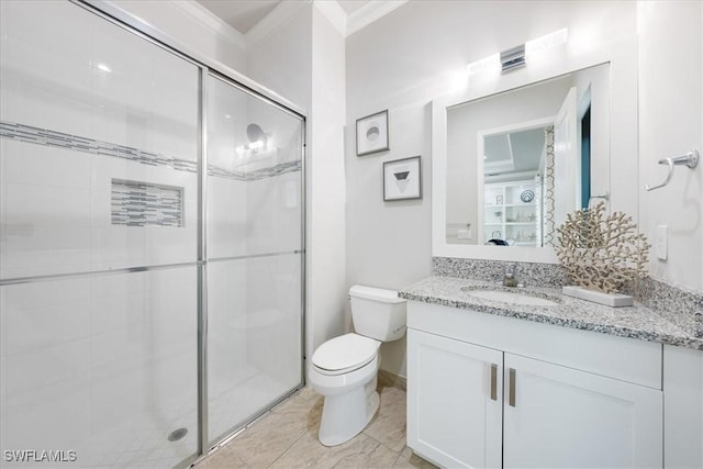 bathroom with toilet, vanity, ornamental molding, and walk in shower