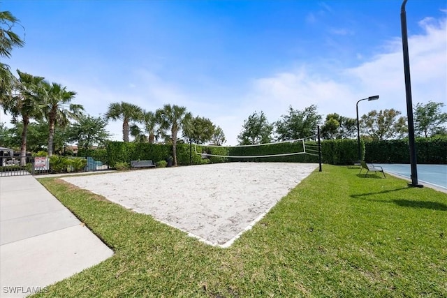 view of property's community featuring volleyball court and a yard