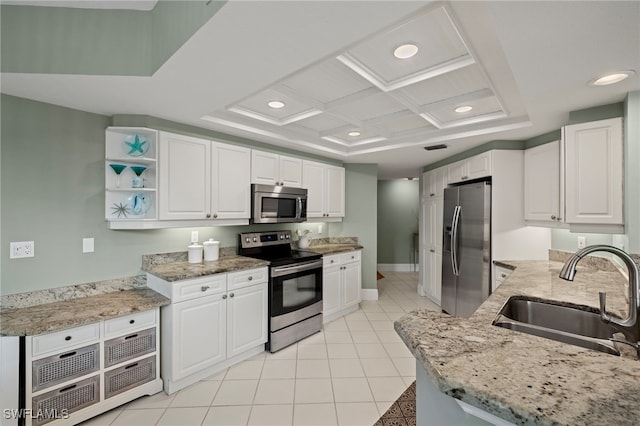 kitchen featuring light stone countertops, stainless steel appliances, white cabinetry, and sink