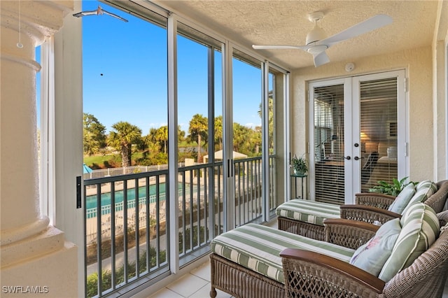 sunroom with ceiling fan and french doors