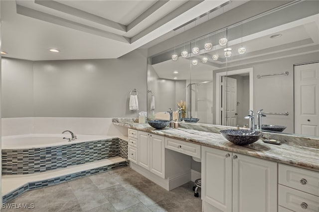 bathroom with vanity, separate shower and tub, and a tray ceiling