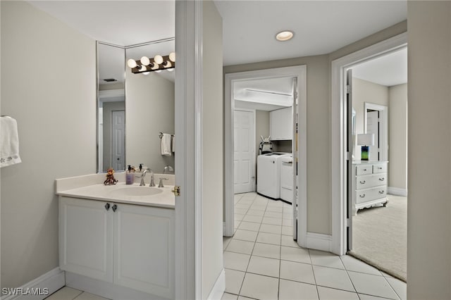 bathroom featuring tile patterned floors, vanity, and independent washer and dryer