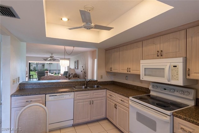 kitchen featuring sink, light brown cabinets, a raised ceiling, white appliances, and light tile patterned floors