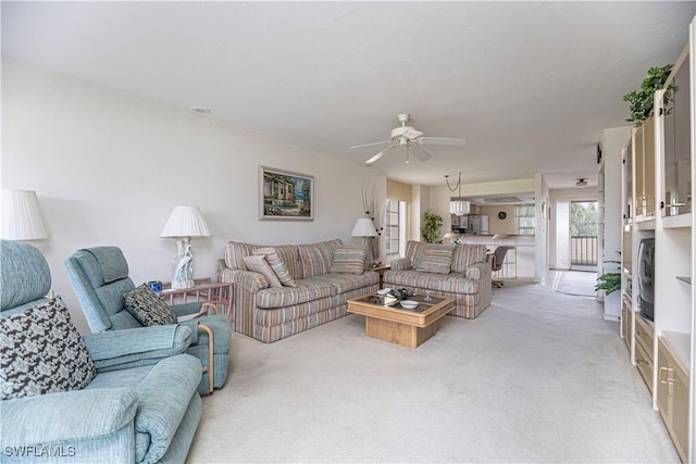 carpeted living room featuring ceiling fan