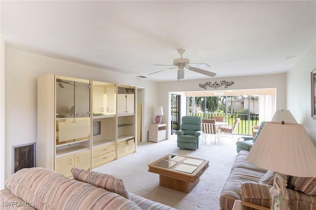 carpeted living room with ceiling fan