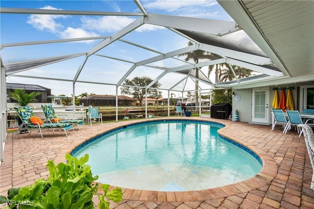 view of swimming pool with a lanai and a patio