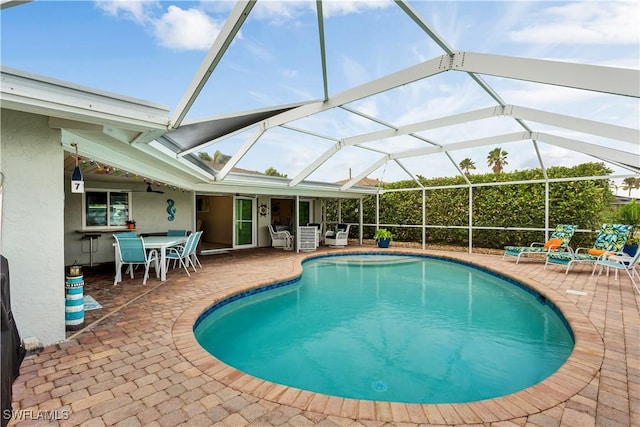 view of pool with a lanai and a patio