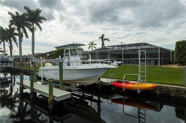 dock area featuring a water view and a lawn