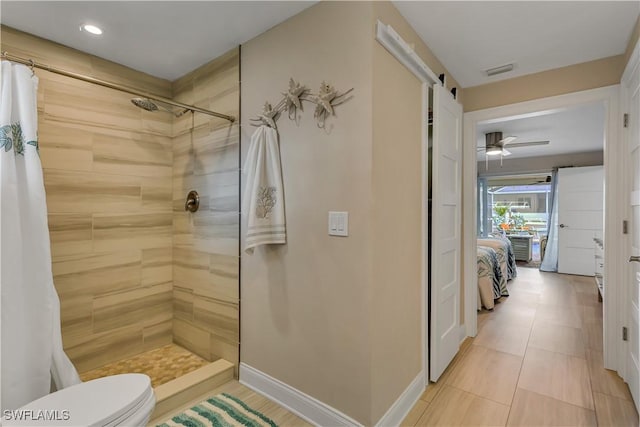 bathroom with tile patterned floors, toilet, walk in shower, and ceiling fan