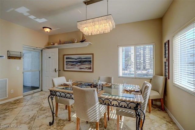 dining area with a notable chandelier and plenty of natural light