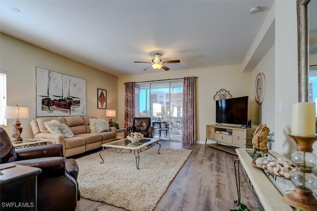 living room with hardwood / wood-style floors and ceiling fan