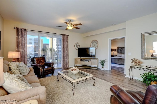 living room with light wood-type flooring and ceiling fan