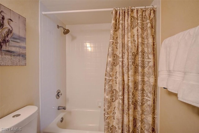 bathroom with toilet and shower / tub combo with curtain