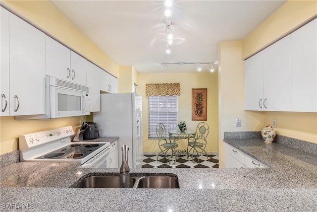 kitchen featuring white cabinetry, sink, dark stone counters, and white appliances