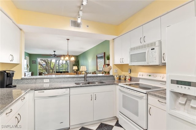 kitchen with white appliances, track lighting, white cabinets, ceiling fan with notable chandelier, and sink