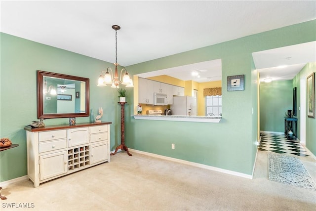 dining space with light carpet and a notable chandelier