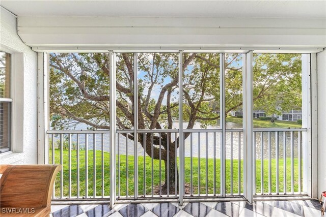 unfurnished sunroom with a water view and a wealth of natural light