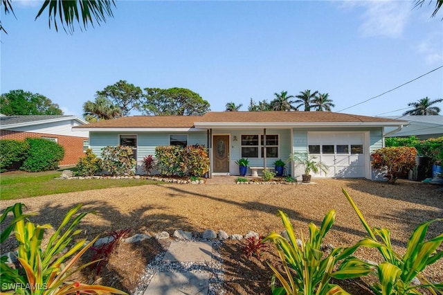 ranch-style home with driveway and an attached garage