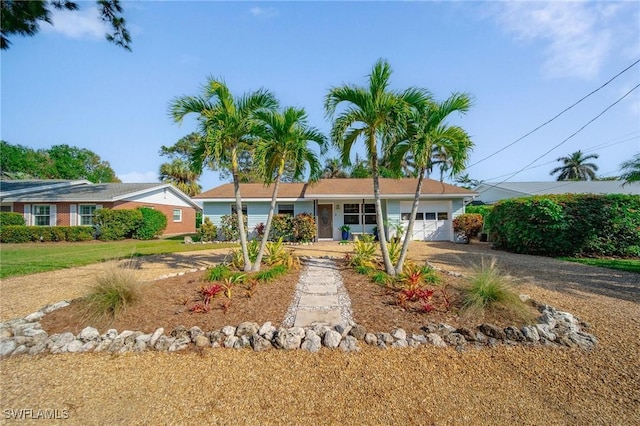 single story home featuring driveway and an attached garage