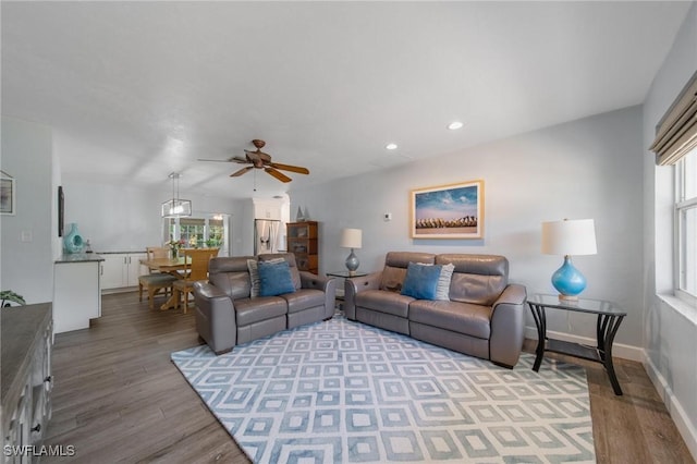 living room featuring light wood-type flooring, a healthy amount of sunlight, baseboards, and recessed lighting