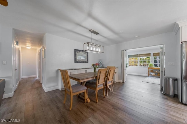 dining room with wood finished floors and baseboards