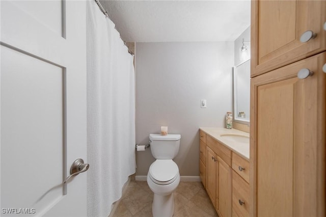 full bath with baseboards, vanity, toilet, and tile patterned floors