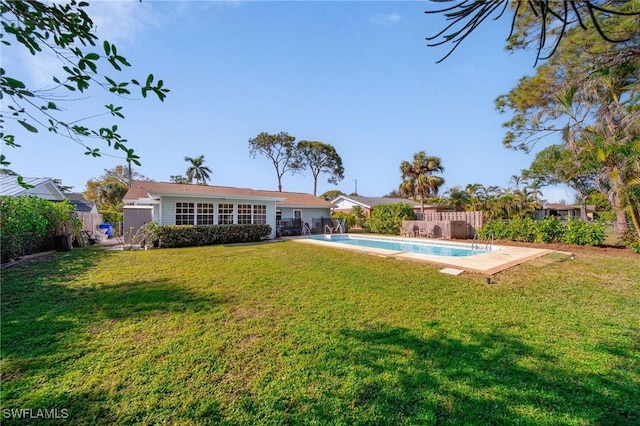 exterior space with a fenced in pool, a fenced backyard, and a yard