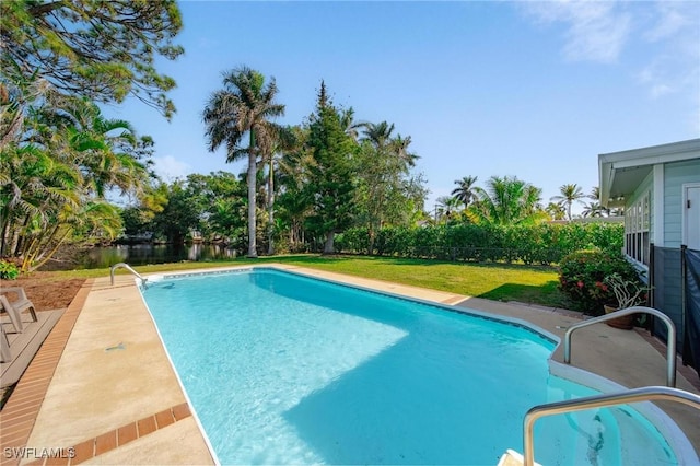 view of pool featuring a yard, a water view, a fenced backyard, and a fenced in pool