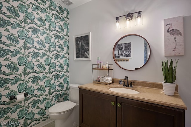 bathroom featuring vanity and toilet