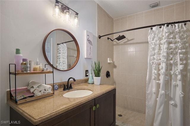 bathroom featuring curtained shower and vanity