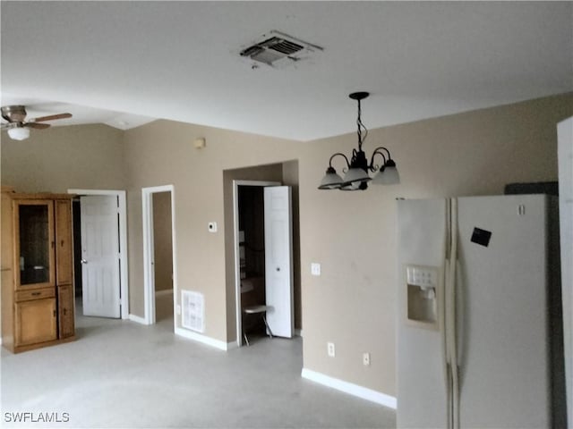 interior space featuring ceiling fan with notable chandelier and vaulted ceiling